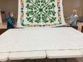 Placing completed applique pattern, on top of the batting and backing piece